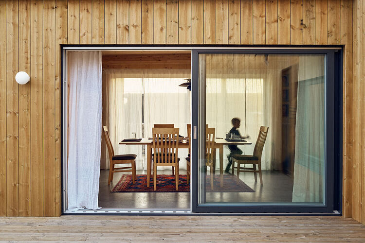 Veliki prozori i klizeća vrata ispunjavaju unutrašnjost doma prirodnom svetlošću